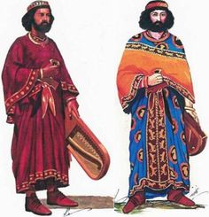 two men dressed in medieval clothing standing next to each other