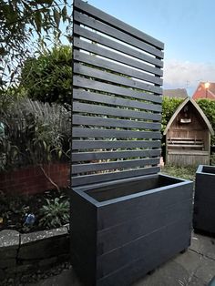 a black planter sitting in the middle of a yard