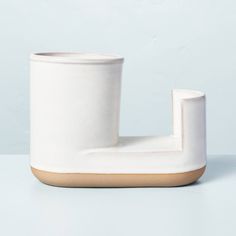 a white ceramic pipe holder sitting on top of a table