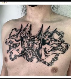 a man's chest with three dogs on it and one dog has its mouth open