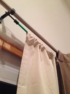 the curtain is pulled up to reveal a green handle