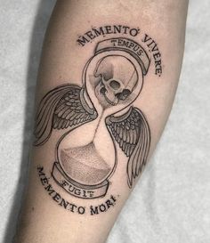 a black and white tattoo with an hourglass on the arm that says mementoo vier