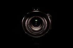 a camera lens is shown in the dark