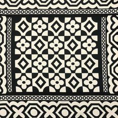 a black and white tile with geometric designs