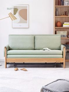 a living room filled with furniture and a book shelf on the wall next to it