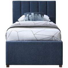 a bed with blue upholstered headboard and pillows