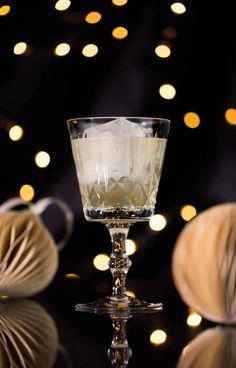 a glass filled with liquid sitting on top of a table