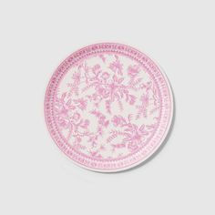 a pink and white plate with flowers on it