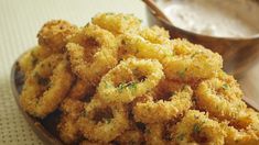 some fried food is on a plate next to a spoon