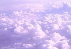 the view from an airplane looking down on clouds