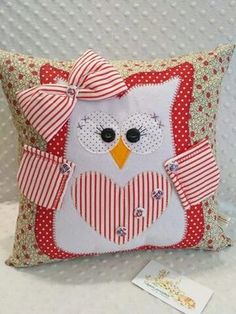 an owl pillow with a bow on it