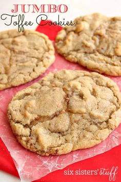 four chocolate chip cookies sitting on top of a red napkin with the words jumbo coffee cookies