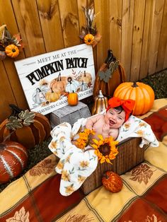 a baby in a pumpkin costume is laying down