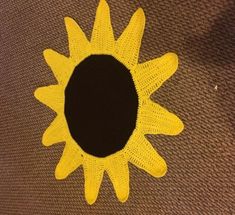 a crocheted sunflower with a black center