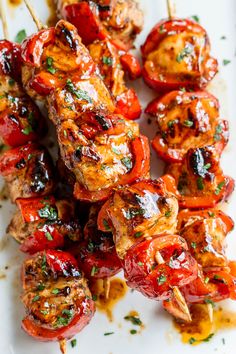 chicken kabobs on skewers covered in marinara sauce