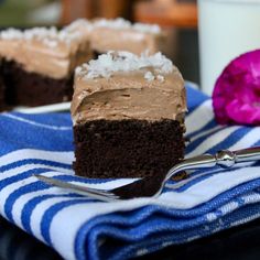 two pieces of chocolate cake on a blue and white towel