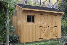 a large wooden shed in the middle of a yard