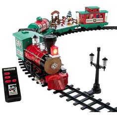 a toy train is shown with its lights on and the tracks are connected to a remote control