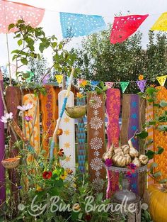 an outdoor garden with colorful flags and vegetables