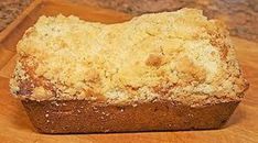 a loaf of bread sitting on top of a wooden cutting board