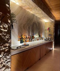 a long bar with many bottles on it