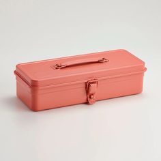 a pink suitcase sitting on top of a white table