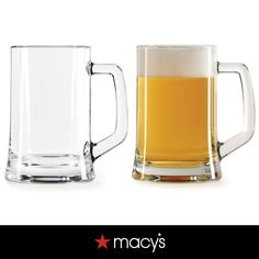 two glass mugs filled with beer sitting next to each other