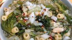 a white bowl filled with pasta and vegetables