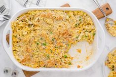 a casserole dish with noodles, peas and parmesan cheese