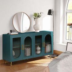 a living room with a blue cabinet and mirror