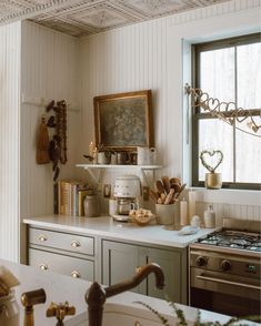 a kitchen with a sink, stove and window