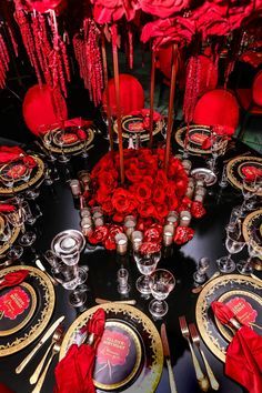 the table is set with red roses and silverware for an elegant valentine's day dinner