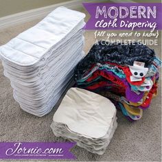 a pile of cloth diapers sitting on the floor next to a pile of folded ones