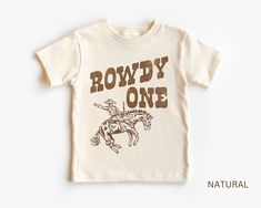 a t - shirt that says rowdy one on it with a cowboy riding a horse