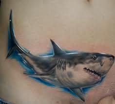 a man's stomach with a shark tattoo on it