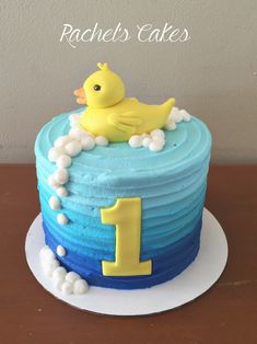 a blue and yellow cake with a rubber ducky on top