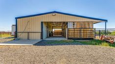 a horse barn with an open door on the side