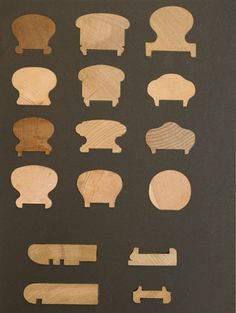 wooden cutouts of different shapes and sizes on a black background with white writing in the middle