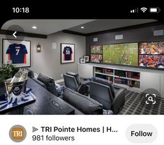 a sports themed living room with couches, chairs and televisions on the wall