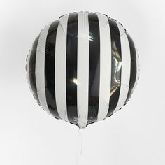 a black and white balloon floating in the air