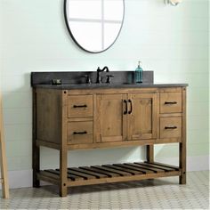 a bathroom vanity with a mirror above it