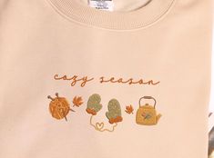 Embroidered Autumn Leaves Sweatshirt, Embroidered Ghost Reading Fall Sweatshirt, Vintage Fall Hoodie, Fall Season, Thanksgiving gift This sweatshirt is crafted from high-quality cotton weave and features advanced embroidery technology to ensure vibrant colors and intricate patterns. It's unisex, soft, and comfortable, making it perfect for a stylish, casual look. Each sweatshirt boasts a unique aesthetic, making it a timeless gift for family, friends, or teachers. Size: We offer a range of color Embroidered Ghost, Ghost Reading, Fall Tshirt, Advanced Embroidery, Fall Reading, Autumn T Shirts, Fall Hoodies, Vintage Fall, Sweatshirt Vintage