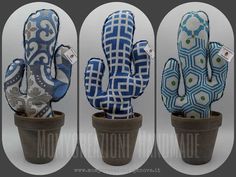 three potted plants with blue and white designs on them, one in a planter