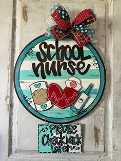 a door hanger that says school nurse and has a heart in the center with two hearts on it