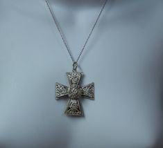 "Beautiful vintage silver filigree cross pendant. The piece is marked, but not very legible. The marking is 800 for the silver. The cross is 1-1/4\" long and 1-1/8\" wide The chain is not as old as the pendant, and is 18 inches long. The piece has been lightly hand polished with a jewelers cloth." Silver Etched Cross Necklace, Vintage Nickel-free Cross Necklace, Ornate Silver Cross Jewelry, Ornate Cross Necklace With Intricate Design, Silver Filigree Cross Necklace, Silver Filigree Cross Jewelry, Ornate Silver Cross Pendant Necklace, Silver Cross Jewelry With Filigree Details, Ornate Silver Cross Necklace