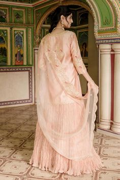 Peach kurta with all over marori floral embroidery and gota embellishments. Comes with can can attached lehenga and dupatta.
Components: 3
Pattern: Embroidered
Type Of Work: Thread, Gota, Marori
Neckline: Notched
Sleeve Type: Three quarter
Fabric: Lehenga and Kurta: Pure Spun Silk, Dupatta: Pure Organza
Color: Peach
Other Details: 
Attached lining
Approx. Product Weight: 2.50kg
Model Height: 5 ft 7 inches, wearing size S
Note: Only selling the product mentioned in description
Occasion: Sangeet,R Pink Slub Silk Set With Dori Work, Raw Silk Sets With Sheer Dupatta, Wedding Straight Kurta Set With Gota Work, Reception Straight Kurta Sets, Tissue Silk Traditional Drape Sets, Pink Slub Silk Set For Wedding, Straight Kurta Sets For Reception, Floor-length Sets With Dori Work, Chinon Sets With Dupatta