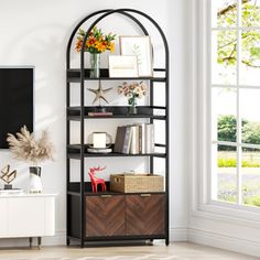 a living room filled with furniture and a flat screen tv on top of a wooden shelf