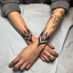 two people with matching tattoos on their arms