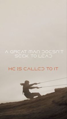 a man is climbing up a hill with a rope