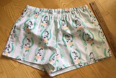 "Horses/Horseshoe theme on green and white striped background flannel sleep shorts 100% cotton flannel Enclosed elastic waistband with 1/2\" non-roll elastic Low rise Side seams 2\" inseam on all sizes Hip sizing: XS(32-34\"), S(35-37\"), M(38-40\"), L(41-43\") Front rise: XS(9 3/4\"), S(10 1/2\"), M(11 1/2\"), L(12 3/4\") Back rise: XS(13 1/2\"), S(14 1/2\"), M(16\"), L(16 3/4\") Measurements are approximate Sizing allows for about 2-3 inches of ease/shorts run a size smaller than the pants All Green Pajama Shorts For Spring Sleepover, Green Relaxed Fit Cotton Pajama Shorts, Green Cotton Pajama Shorts For Sleep, Green Pajama Shorts For Sleepover, Cotton Shorts For Bedtime, Green Cotton Pajama Shorts With Elastic Waistband, Cotton Bedtime Shorts, Green Pajama Shorts For Summer Sleepover, Summer Green Shorts For Pajama Party